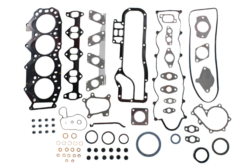 Automotive gasket set with various components on a white background