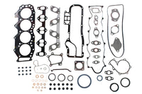 Automotive gasket set with various components on a white background